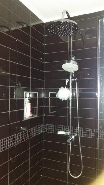 Black tiled rain shower completed by Mallon Building