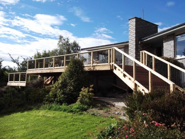 Elevated timber deck and stair addition to a brick home