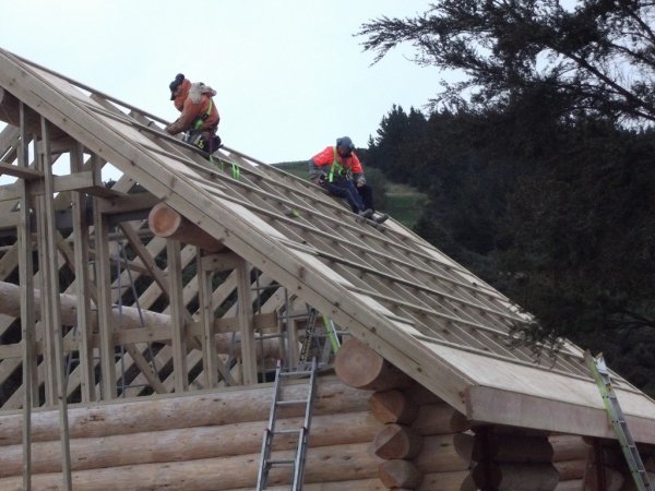 Mallon Building carpenters constructing a log cabin roof