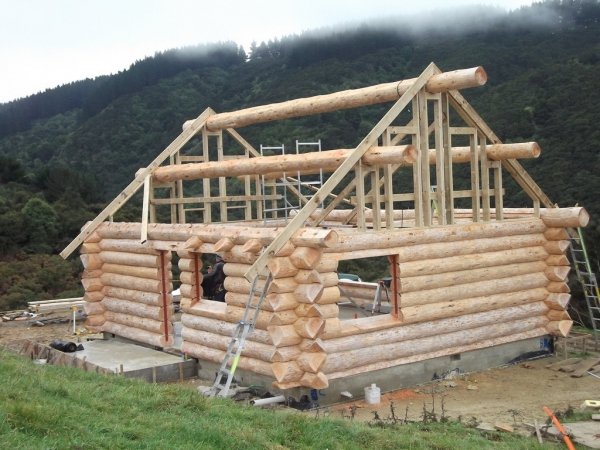 Log cabin wall and roof frame under construction